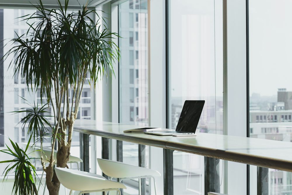 Desk with a laptop in a bright office
